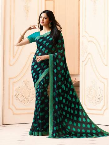 Grab This Pretty Saree In Navy Blue Color Paired With Contrasting Blue Colored Blouse. This Saree Is Fabricated On Georgette Paired With Art Silk Fabricated Blouse. This Saree Has Pretty Paisly Prints All Over It. Buy Now.