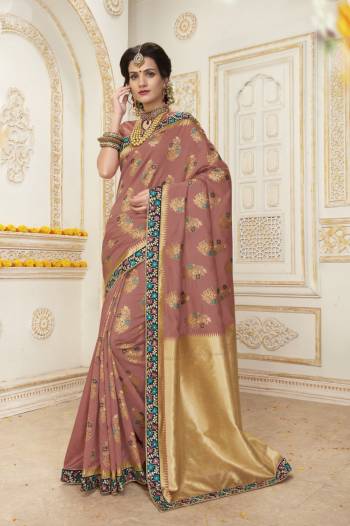 Add This Very Beautiful And Unique Color To Your Wardrobe Wearing This Saree In Dusty Pink Color Paired With Dusty Pink Colored Blouse. This Saree And Blouse Are Fabricated On Jacquard Silk With Very Beautifully Combined Weaving And Embroidery. Buy Now.