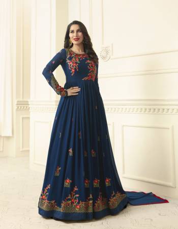 Add This Very Pretty Shade Of Blue With This Designer Floor Suit Paired With Blue Colored Bottom And Dupatta. Its Top Is Fabricated On Georgette Paired With Santoon Bottom And Chiffon Dupatta. It Has Contrasting Floral Embroidery Making The Suit Attractive. Buy Now.