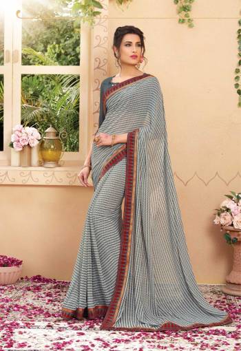 Grab This Checks Printed Saree In Grey Color Paired With Grey Colored Blouse. This Saree And Blouse are Fabricated On Georgette Which Is Light Weight And Easy To Carry All Day Long.