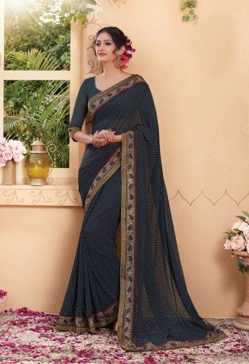 You Will Definitely Earn Lots Of Compliments Wearing This Saree In Dark Grey Color Paired With Dark Grey Colored Blouse. This Saree And Blouse Are Fabricated On Georgette Beautified With Prints All Over It. This Saree Will Give An Elegant Look Like Never Before.