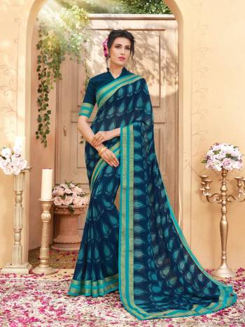 Adorn The Bold Look, Wearing This Saree In Dark Blue Color Paired With Dark Blue Colored Blouse. This Saree And Blouse are Fabricated On Georgette Beautified With Bold Prints All Over The Saree. Buy This Saree Now.