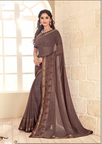 Flaunt Your Rich And Elegant Taste Wearing This Saree In Brown Color Paired With Brown Colored Blouse. This Saree And Blouse are Fabricated On Georgette Beautified With Intricate  Prints All Over It. It Is Durable And Easy To Care For.