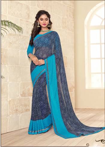 Adorn The Bold Look, Wearing This Saree In Dark Blue Color Paired With Blue Colored Blouse. This Saree And Blouse are Fabricated On Georgette Beautified With Prints All Over The Saree. Buy This Saree Now.