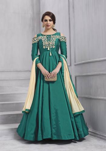 Here Is A Cold Shoulder Patterned Readymade Designer Floor Length Suit In Teal Green Colored Top Paired With Teal Green Colored Bottom And Cream Colored Dupatta. Its Top Is Fabricated On Art Silk Paired With Santoon Bottom And Chiffon Dupatta. Buy This Readymade Suit Now.