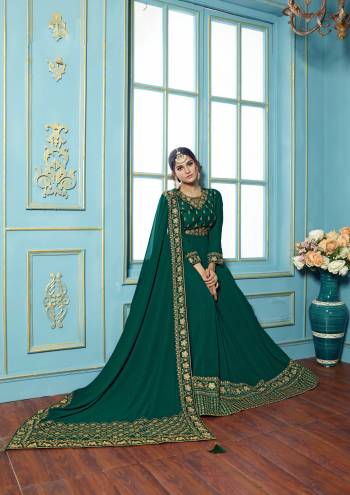 Add This Very Pretty And Attractive Shade Of Green To Your Wardrobe With This Designer Floor Length Suit In Pine Green Colored Top Paired With Pine Green Colored Bottom And Dupatta. Its Top Is Fabricated On Georgette Paired With Santoon bottom And Georgette Dupatta. Its Heavy Embroidery Over The Top And Dupatta Will Earn You Lots Of Compliments From Onlookers.