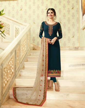 New And Unique Shade Of Blue Is Here With This Designer Straight Cut Suit In Prussian Blue Colored Top Paired With Prussian Blue Colored Bottom And Off-White Colored Dupatta. Its Top Is Fabricated On Georgette Paired With Santoon Bottom And Net Dupatta. It Is Beautified With Contrasting Embroidery Over The Top And Dupatta.