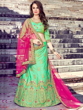 Grab This Pretty Shade In Green With This Designer Light Green Colored Lehenga Choli Paired With Contrasting Rani Pink Colored Dupatta. Its Blouse And Lehenga Are Fabricated On Art Silk Paired With Net Fabricated Dupatta. This Lehenga Choli Has Heavy Embroidery All Over It. Buy It Now.