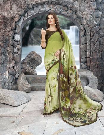 Go Green With This Pretty Simple Sareee In Green Color Paired With Contrasting Brown Colored Blouse. This Saree And Blouse Are Fabricated On Georgette Beautified With Prints All Over It. Its Unique Combination Will Earnm You Lots Of Compliments.