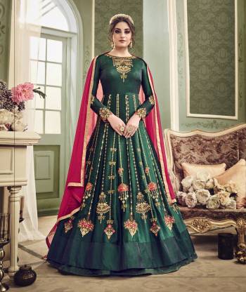 Enhance Your Beauty Wearing This Designer Floor Length Suit In Pine Green Color Paired With Pine Green Colored Bottom And Contrasting Dark Pink Colored Dupatta. Its Top Is Fabricated On Art Silk Paired With Santoon Bottom And Chiffon Dupatta. It Has Heavy Embroidery All Over The Suit Making The Suit More Attractive. Buy Now.