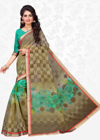 Add This New Shade In Green To Your Wardrobe With This Casual Saree In Olive Green Color Paired With Sea Green Colored Blouse. This Saree Is Fabricated On Cotton Silk Paired With Art Silk Fabricated Blouse. It Is Light Weight And Easy To Carry All Day Long.