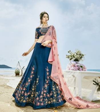 Here Is A Beautiful Designer Lehenga Choli In Cobalt Blue Color Paired With Contrasting Light Pink Colored Dupatta. Its Blouse and Lehenga Are Fabricated On Art Silk Paired With Net Fabricated Dupatta. It Has Contrasting Embroidery Over The Blouse And Lehenga. Its Beautiful Color Combination And Embroidery Will Earn You Lots Of Compliments From Onlookers.