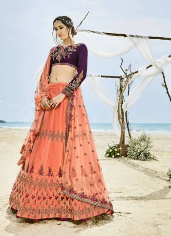 Get Ready For The Upcoming Festive And Wedding Season With This Designer Lehenga Choli In Wine Colored Blouse, Paired With Peach Colored Lehenga And Dupatta. Its Blouse Is Fabricated On Velvet Silk Paired With Art Silk Lehenga And Net Dupatta. It Is Beautified With Heavy Embroidery All Over.