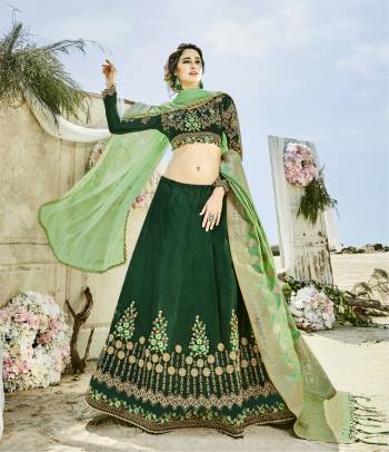 Attract All Wearing This Designer Lehenga Choli In Dark Green Color Paired With Pastel Green Colored Two Dupattas. Its Blouse Is Fabricated On Velvet Silk Paired With Art Silk Lehenga And One Net Dupatta & Another Banarsi Art Silk Fabricated Dupatta. This Lehenga Choli Can Be Paired With Any Of The Dupattas As Per Your Convinience. Buy Now.