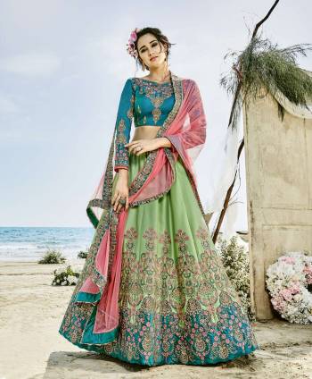 Go Colorful Wearing This Designer Lehenga Choli In Blue Colored Blouse Paired With Contrasting Light Green Colored Lehenga And Pink Colored Dupatta. Its Blouse And Lehenga Are Fabricated On Art Silk Paired With Net Fabricated Dupatta. It Is Beautified With Heavy Embroidery All Over Which Is Making The Lehenga Choli More Attractive. 