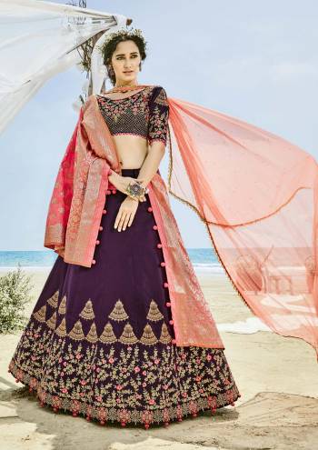 A Must Have Shade In Every Womens Wardrobe Is Here, Grab This Designer Lehenga Choli In Wine Color Paired With Contrasting Two Dupattas In Peach Color. Its Blouse And Lehenga Are Fabricated On Velvet Silk Paired With One Net And Another Banarasi Art Silk Dupatta. Its Beautiful Color Combination Will Definitely Earn You Lots Of Compliments From Onlookers.