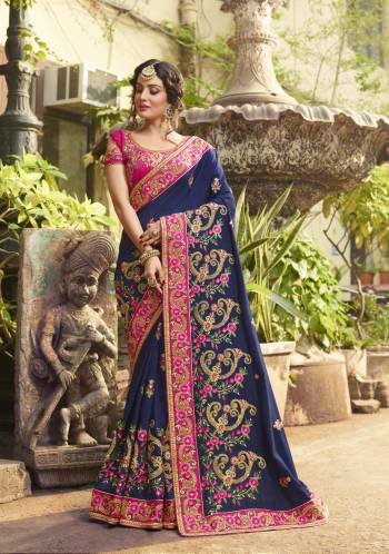 Enhance Your Personality Wearing This Designer Saree In Navy Blue Color Paired With Contrasting Dark Pink Colored Blouse. This Saree And Blouse Are Fabricated On Art Silk Beautified With Heavy Embroidery Making The Saree More Attractive. Buy Now.