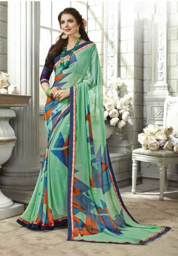 Here Is A Pretty Shade In Green With This Saree In Sea Green Color Paired With Contrasting Navy Blue Colored Blouse. This Saree Is Fabricated On Georgette Paired With Art Silk Fabricated Blouse. Buy This Elegant Saree Now.