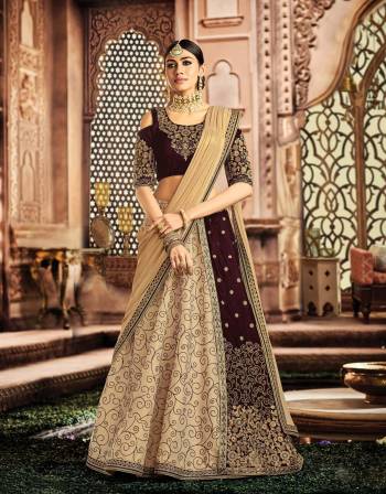 Redefine the legacy of time-honoured styles combined with a modern feel to it in this fusion lehenga in the beautiful shades of Wine And Beige and look magnificent. 