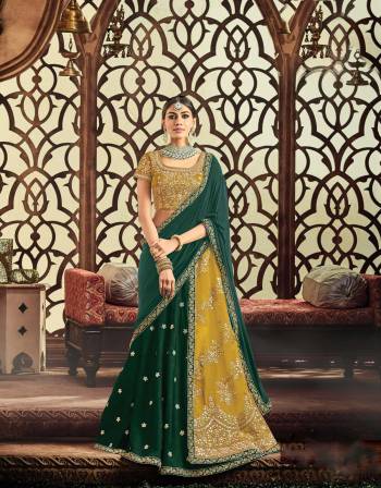 Define your inner empress with utmost panache and flamboyance in this mustard Yellow and Pine green lehenga adorned with gota embroidery.