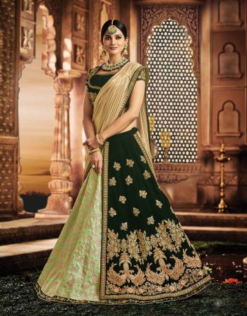 Exude a magnificent appeal and look radiant in this peacock-motif embellished two-layered lehenga in stunning shades of green and embrace the ethnic look in style. 