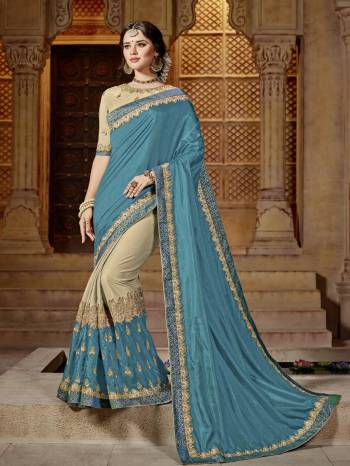 Show your elegance by wearing this gorgeous Blue and beige color two tone silk and glitter lycra saree. Ideal for party, festive & social gatherings. this gorgeous saree featuring a beautiful mix of designs. Its attractive color and designer embroidered design, patch design, stone, beautiful floral design work over the attire & contrast hemline adds to the look. Comes along with a contrast unstitched blouse.