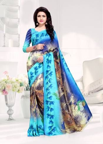 Here Is A Saree In Shades Of Blue Color Paired With Blue Colored Blouse. This Saree And Blouse Are Fabricated On Crepe Silk Beautified With Prints All Over It.