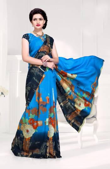 Here Is A Saree In Shades Of Blue Color Paired With Blue Colored Blouse. This Saree And Blouse Are Fabricated On Crepe Silk Beautified With Prints All Over It.