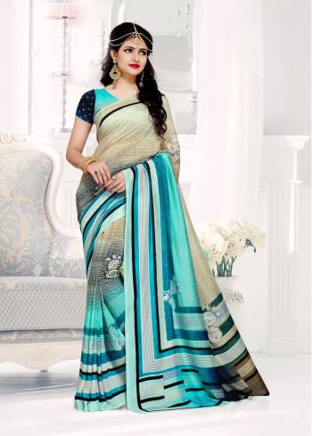 Here Is A Saree In Shades Of Blue Color Paired With Blue Colored Blouse. This Saree And Blouse Are Fabricated On Crepe Silk Beautified With Prints All Over It.