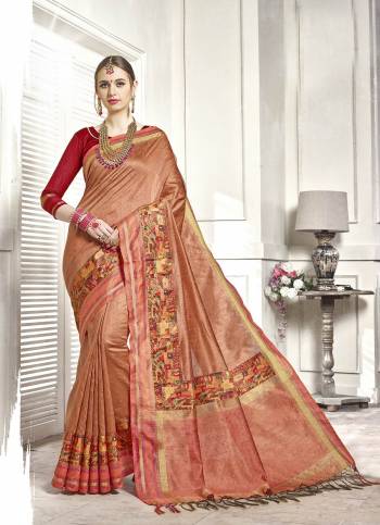 A Must Have Color In Every Womens Wardrobe Is Here With This Saree In Peach Color Paired With Contrasting Red Colored Blouse. This Saree And Blouse Are Fabricated On Art Silk Beautified With Prints. Buy It Now.