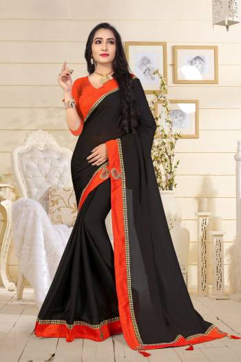 Enhance Your Beauty wearing This Saree In Black Color Paired With Orange Colored Blouse. This Saree Is Fabricated On Satin Silk Paired With Art Silk Fabricated Blouse. Both Its Fabrics Are Soft Towards Skin And Also Light In Weight Which Is Easy To Carry All Day Long.