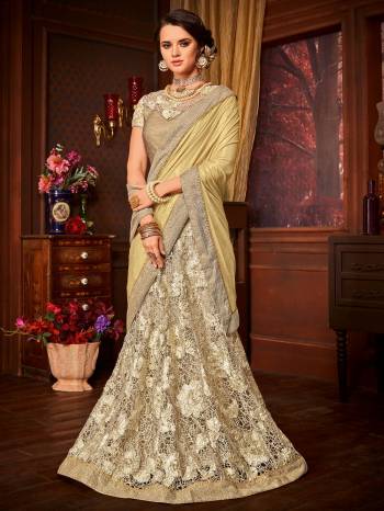 Presenting this golden And Cream color Imported coated fabrics & diamond Net fabrics with Heavy work & jacquard border saree. Ideal for party, festive & social gatherings. this gorgeous saree featuring a beautiful mix of designs. Its attractive color and designer embroidered saree, stone, heavy designer blouse and beautiful floral design work over the attire & contrast hemline adds to the look. Comes along with a contrast unstitched blouse.