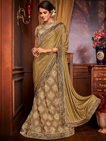 you Look striking and stunning afler wearing this golden and beige color Imported coated fabrics & diamond Net fabrics with Heavy work & jacquard border saree. look gorgeous at an upcoming any occasion wearing the saree. this party wear saree won't fail to impress everyone around you. Its attractive color and designer embroidered saree, moti design, stone, heavy designer blouse and beautiful floral design work over the attire & contrast hemline adds to the look. Comes along with a contrast unstitched blouse.