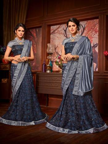 Impress everyone with your amazing Trendy look by draping this grey and Navy Blue color Imported coated fabrics & diamond Net fabrics with Heavy work & jacquard border saree. this party wear saree won't fail to impress everyone around you. this gorgeous saree featuring a beautiful mix of designs. Its attractive color and designer embroidered saree, moti line border, stone, heavy designer blouse and beautiful floral design work over the attire & contrast hemline adds to the look. Comes along with a contrast unstitched blouse.