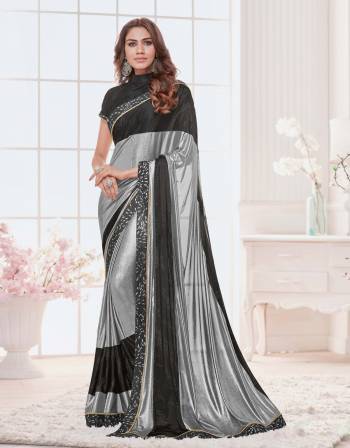 Go Colorful This Season With This Silver , Black Colored Saree Paired With Black Colored Blouse.  This Saree Is Fabricated On Lycra Paired With Raw Silk Fabricated Blouse.Grab This Designer Saree Now.