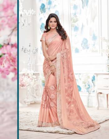 New And Unique, Add This Peach Colored Saree Paired With Peach Colored Blouse. This Saree Is Fabricated On Lycra Paired With Raw Silk Fabricated Blouse. It Is Soft Towards Skin And Easy To Carry All Day Long.Grab This Designer Saree Now.