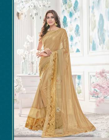 Look Beautiful Wearing This Gold Colored Saree At The Next Function You Visit Paired With Contrasting Gold Colored Blouse. This Saree Is Made From  Lycra Net Paired With Raw Silk Fabricated Blouse.Grab This Designer Saree Now.