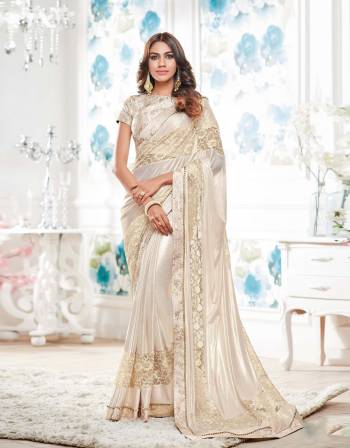 Here Is A Every Womens Favourite Colored Attire. Grab This Cream Colored Saree Paired With Cream Colored Blouse.This Saree Is Fabricated On Lycra Paired With Brocade Fabricated Blouse.Buy It Now.