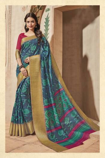 Here Is Silk Saree In Shades Of Blue Paired With Contrasting Dark Pink Colored Blouse. This Saree And Blouse Are Fabricated On Art Silk Beautified With Prints. 