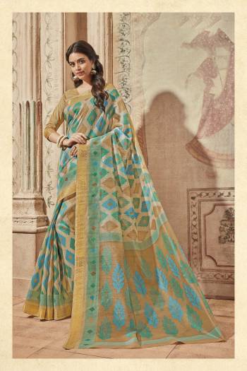 Grab This Pretty Saree In Beige And Blue Color Paired With Beige Colored Blouse. This Saree And Blouse Are Fabricated On Art Silk Beautified With Prints. It Is Light Weight And Easy To Carry All Day Long.