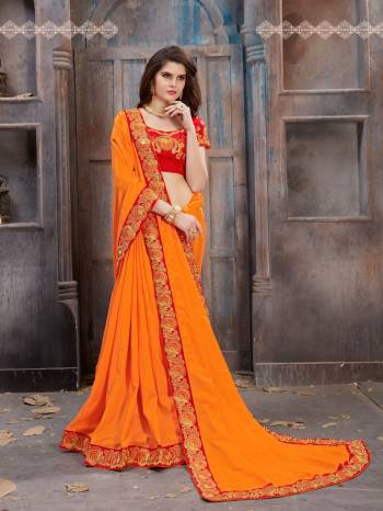 Orange Color Induces Perfect Summery Appeal To Any Outfit And Gives And Fresh And Bright Look Everytime You Wear It. Grab this saree In Orange Color Paired With Contrasting Red Colored Blouse. This Saree Is Fabricated On Satin Silk Paired With Art Silk Fabricated Blouse. Buy This Designer Saree Now.