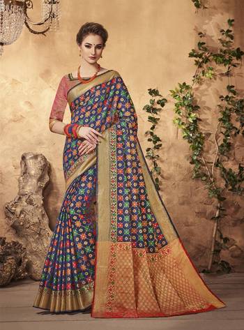 Enhance Your Beauty Wearing This Saree In Navy Blue Color Paired With Contrasting Red Colored Blouse. This Saree And Blouse Are Fabricated On Art Silk Beautified With Multi Colored Weave All Over. 