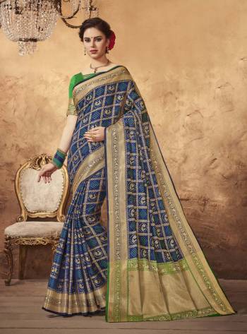 Enhance Your Personality Wearing This Saree In Navy Blue Color Paired With Contrasting Green Colored Blouse. This Saree And Blouse Are Fabricated On Art Silk Beautified With Multi Colored Weave All Over. 