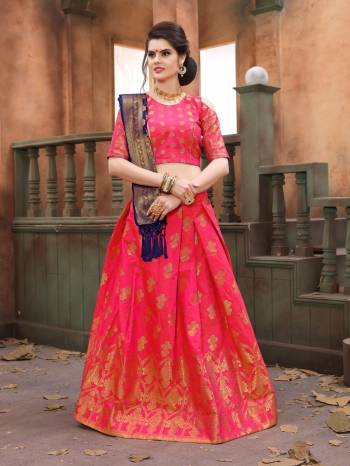 Attract All Wearing This Rich Looking Silk Lehenga Choli In Fuschia Pink Color Paired With Contrasting Navy Blue Colored Dupatta. Its Blouse And Lehenga Are Fabricated On Banarasi Art Silk Paired With Banarasi Art Silk Dupatta. It Is Light Weight, Durable And Easy To Care For.