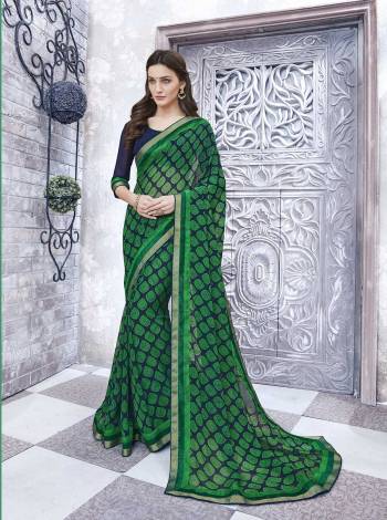 Add Some Casuals With This Pretty Simple Saree In Green And Navy Blue Color Paired With Navy Blue Colored Blouse. This Saree And Blouse Are Fabricated On Georgette Beautified With Prints. It Is Light Weight and Easy To Carry All Day Long.