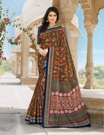 Enhance Your Personality Wearing This Saree In Brown Colore Paired With Contrasting Dark Blue Colored Blouse. This Saree And Blouse Are Fabricated On Tussar Art Silk Beautified With Prints All Over. It Is Light Weight And Easy To Carry All Day Long.