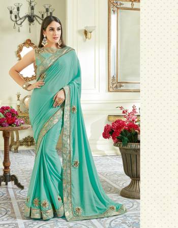 Shape your ethnic wear wardrobe with a touch of contemporary to it with this fresh, summery and feminine aqua blue saree with floral hints. Opt for an equally minimal accessorization to look elegant. 