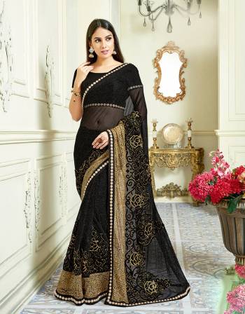 Look impeccably gorgeous for your next evening party in this black on black detailed saree. Exude a never-like before feminine charm by adding statement earrings. 