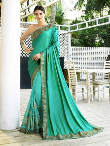 Add This Lovely Saree To Your Wardorbe In Sea Green Color Paired With Beige Colored Blouse. This Saree Is Fabricated On Satin Silk And Georgette Paired With Gota Fabricated Blouse. This Elegant Looking Saree Is Light Weight, Durable and Easy To Care For.