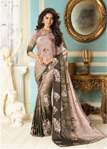 Another Rich Looking Shade Is Here With This Designer Saree In Dusty Pink And Dark Grey Color Paired With Same Colored Matching Blouse. This Saree And Blouse Are Fabricated On Fancy Fabrics Beautified With Floral Prints And Stone Work. Its Fabrics Ensures Superb Comfort Throughout The Gala.